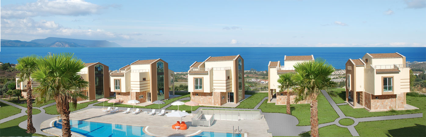 Panoramic photo of luxury complex villas on main soke to kuşadası road. Shows detached Turkish villas. Large shared pool and greenery.